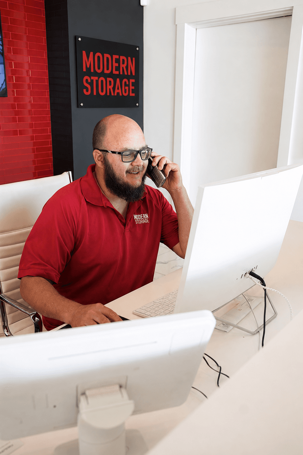 Modern Storage® team member helping a customer by phone from the facility office
